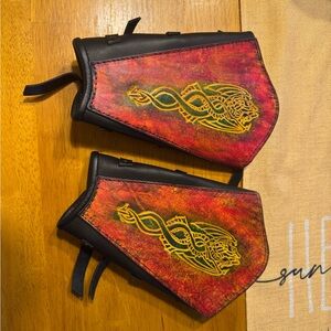 Vibrant Red and Black Leather Arm Guards with Gold Design